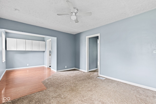 703 Kappes St, Indianapolis, IN 46221 - empty room featuring ceiling fan, light colored carpet, baseboards, and a textured ceiling