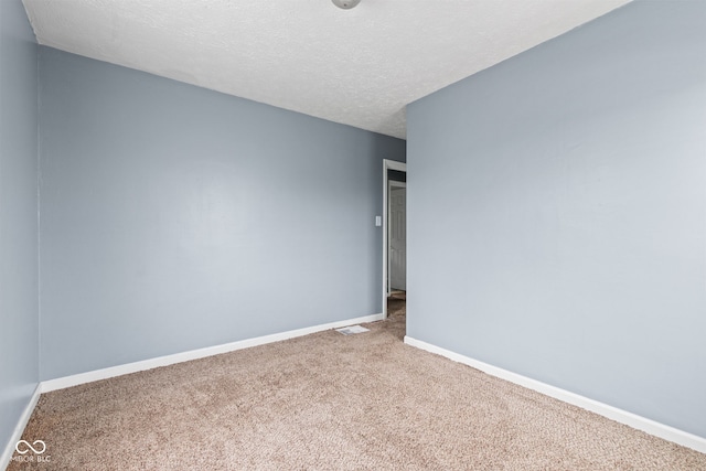 703 Kappes St, Indianapolis, IN 46221 - carpeted empty room featuring baseboards and a textured ceiling