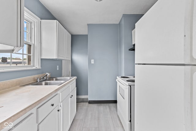 703 Kappes St, Indianapolis, IN 46221 - kitchen with white appliances, a sink, white cabinetry, and baseboards