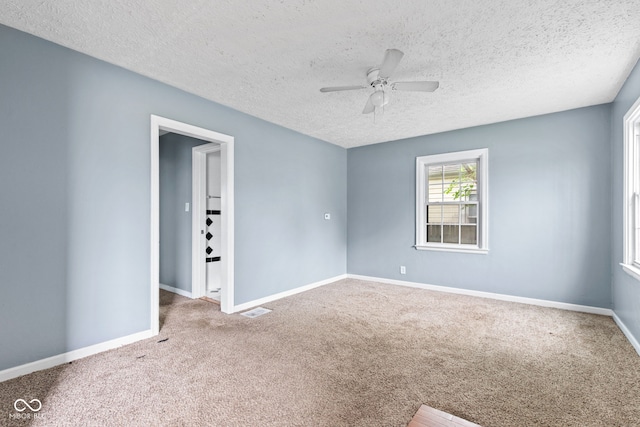 703 Kappes St, Indianapolis, IN 46221 - carpeted spare room with ceiling fan, baseboards, and a textured ceiling
