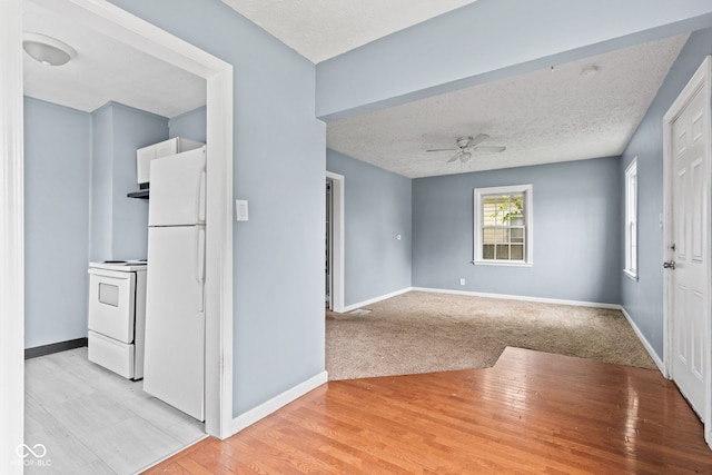 703 Kappes St, Indianapolis, IN 46221 - foyer with ceiling fan, baseboards, a textured ceiling, and light wood-type flooring
