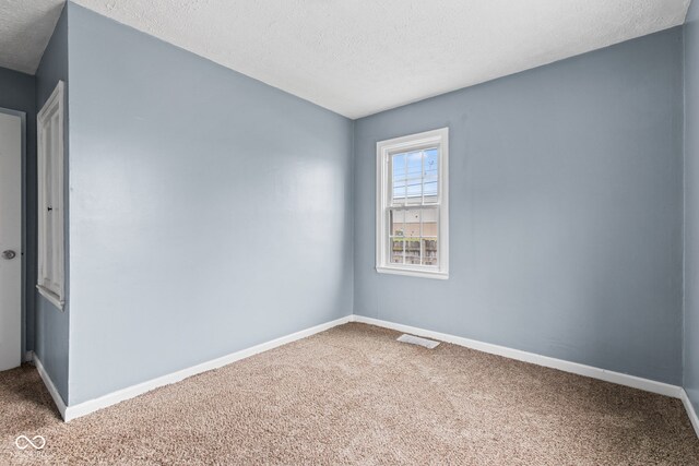 703 Kappes St, Indianapolis, IN 46221 - carpeted empty room with a textured ceiling and baseboards