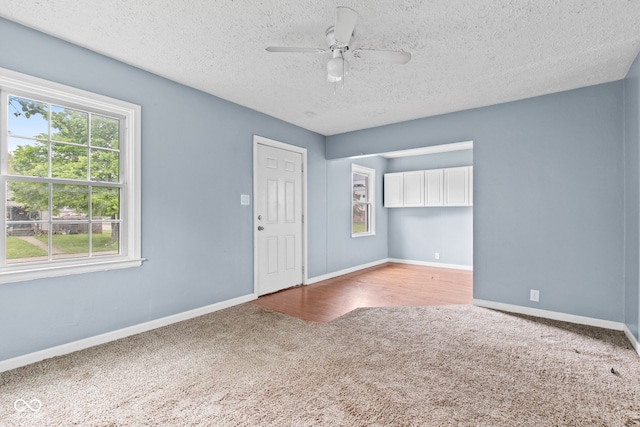 703 Kappes St, Indianapolis, IN 46221 - empty room featuring carpet flooring, a ceiling fan, baseboards, and a textured ceiling