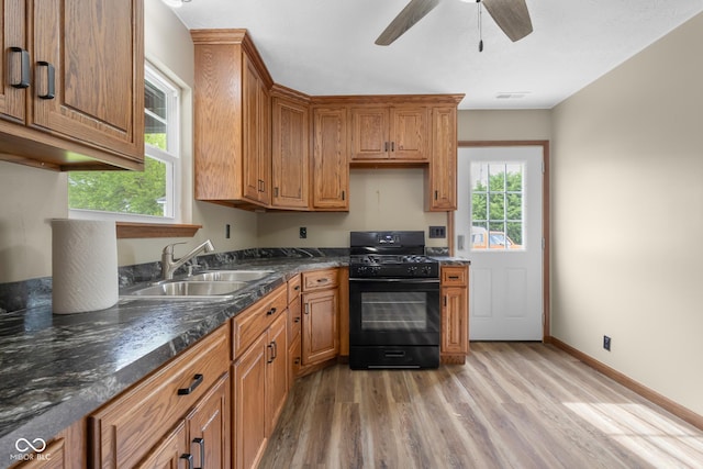 632 W Central Ave, Greensburg, IN 47240 - kitchen with black gas stove, a sink, light wood-style floors, dark countertops, and a ceiling fan