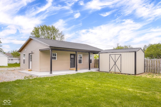 632 W Central Ave, Greensburg, IN 47240 - back of house with an outbuilding, a storage unit, a patio, and metal roof