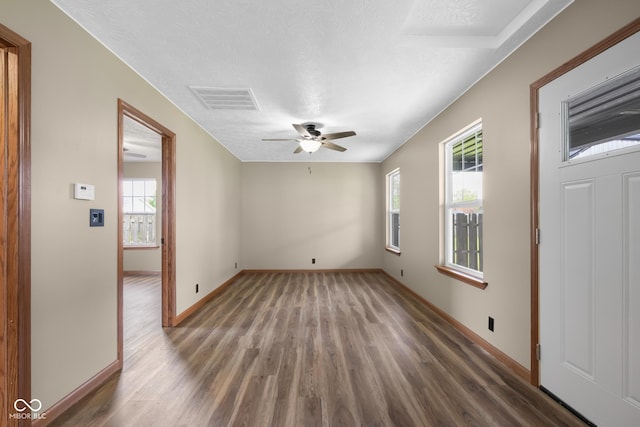 632 W Central Ave, Greensburg, IN 47240 - empty room with wood finished floors, baseboards, ceiling fan, and a textured ceiling