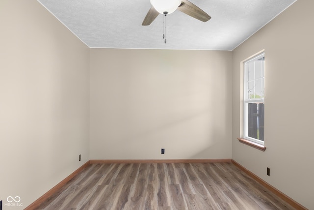 632 W Central Ave, Greensburg, IN 47240 - spare room featuring light wood-style floors, baseboards, ceiling fan, and a textured ceiling