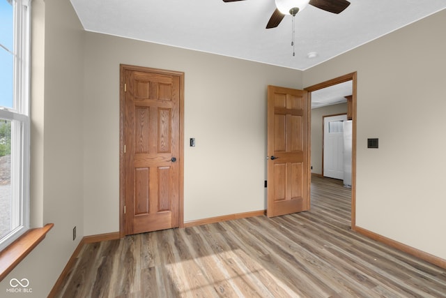 632 W Central Ave, Greensburg, IN 47240 - empty room featuring light wood-style flooring, baseboards, and ceiling fan