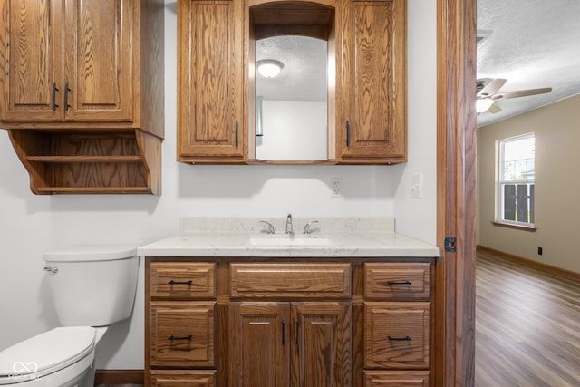 632 W Central Ave, Greensburg, IN 47240 - half bath featuring a textured ceiling, a ceiling fan, baseboards, toilet, and vanity