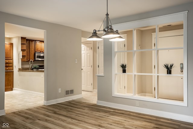 8690 Jaffa Ct W Drive 28, Indianapolis, IN 46260 - unfurnished dining area featuring wood finished floors and baseboards