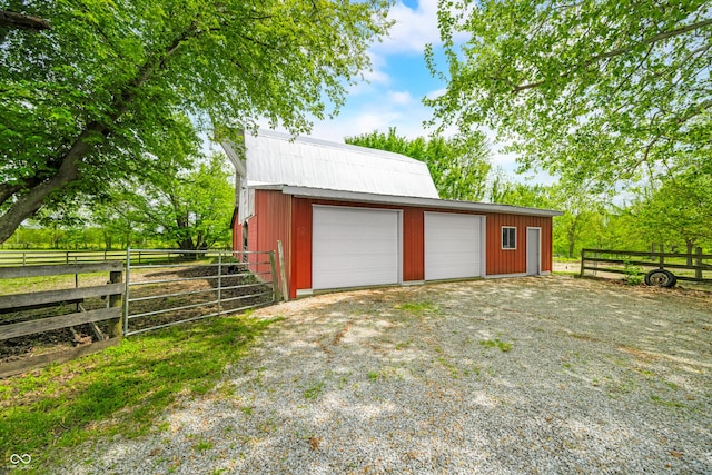detached garage featuring fence