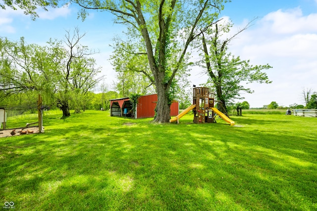 view of green lawn featuring an outbuilding, an outdoor structure, and a playground