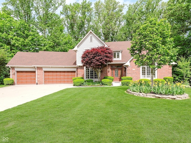 10350 Courageous Dr, Indianapolis, IN 46236 - view of front facade with brick siding, an attached garage, a front lawn, concrete driveway, and roof with shingles
