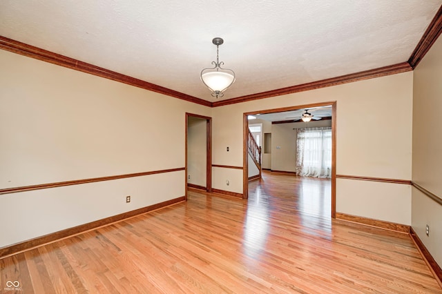 9158 Oak Knoll Ln, Fishers, IN 46037 - spare room with light wood-style flooring, crown molding, stairway, and a textured ceiling