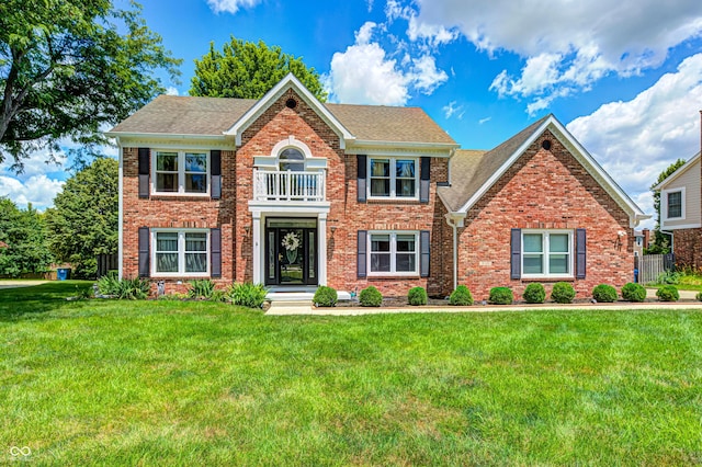 9158 Oak Knoll Ln, Fishers, IN 46037 - colonial house with brick siding, a front yard, and roof with shingles