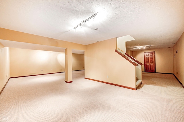 9158 Oak Knoll Ln, Fishers, IN 46037 - finished below grade area featuring rail lighting, carpet, stairway, and a textured ceiling