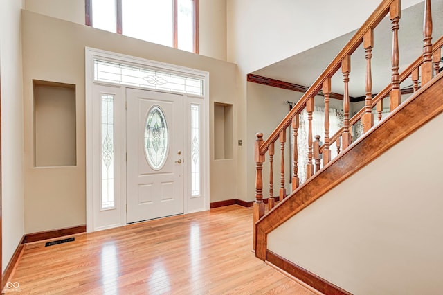 9158 Oak Knoll Ln, Fishers, IN 46037 - foyer with a towering ceiling, plenty of natural light, wood finished floors, and stairs
