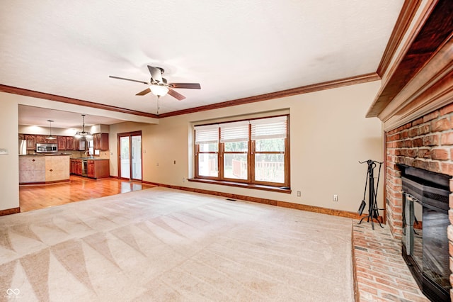 9158 Oak Knoll Ln, Fishers, IN 46037 - unfurnished living room with a brick fireplace, a ceiling fan, crown molding, and light carpet