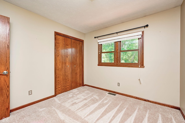 9158 Oak Knoll Ln, Fishers, IN 46037 - unfurnished bedroom with a closet, carpet flooring, and a textured ceiling
