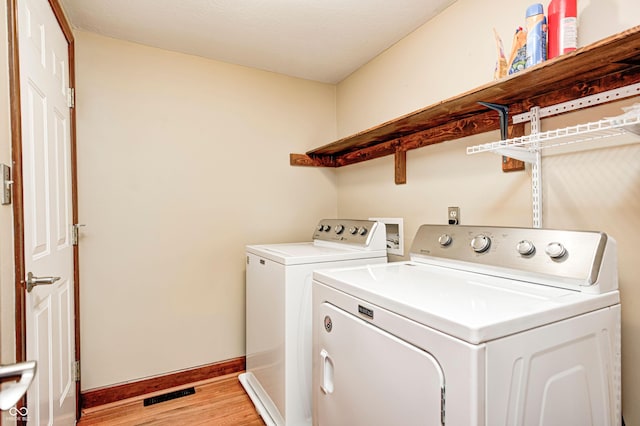 9158 Oak Knoll Ln, Fishers, IN 46037 - laundry area featuring washer and clothes dryer and light wood-style floors