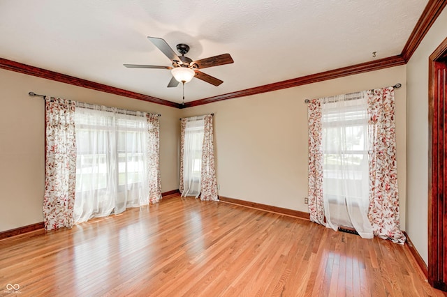 9158 Oak Knoll Ln, Fishers, IN 46037 - spare room with plenty of natural light, light wood finished floors, ceiling fan, and crown molding