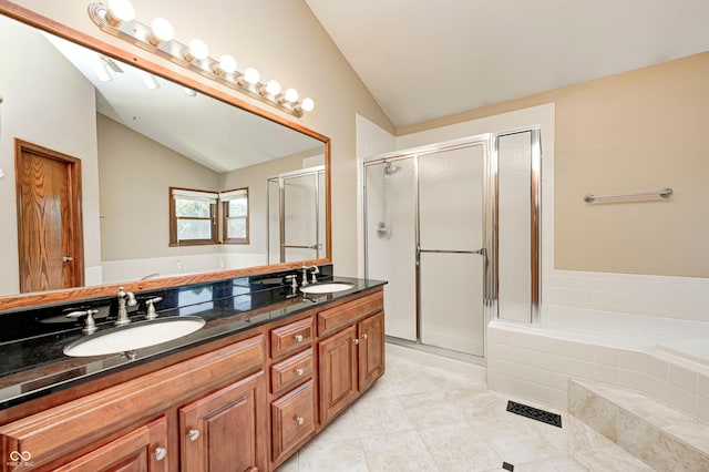 9158 Oak Knoll Ln, Fishers, IN 46037 - bathroom with lofted ceiling, double vanity, a shower stall, a bath, and tile patterned floors