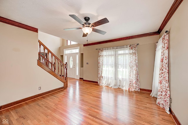 9158 Oak Knoll Ln, Fishers, IN 46037 - unfurnished living room featuring stairs, light wood finished floors, ceiling fan, and crown molding