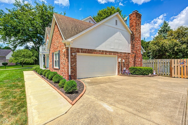 9158 Oak Knoll Ln, Fishers, IN 46037 - view of side of home with brick siding, roof with shingles, an attached garage, driveway, and a chimney
