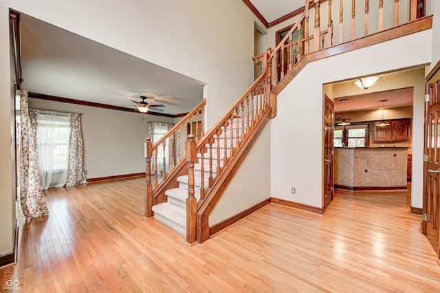 9158 Oak Knoll Ln, Fishers, IN 46037 - stairs featuring crown molding, hardwood / wood-style floors, healthy amount of natural light, and ceiling fan