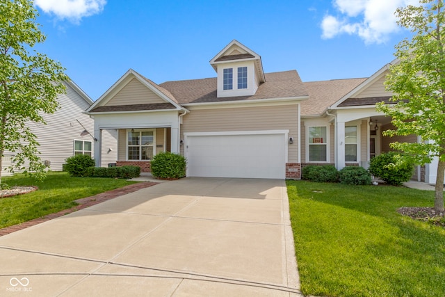4181 Gordman Dr, Whitestown, IN 46075 - view of front of property featuring an attached garage, a front lawn, concrete driveway, a shingled roof, and brick siding