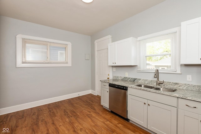 1661 S Talbott St, Indianapolis, IN 46225 - kitchen featuring dishwasher, a sink, baseboards, light stone countertops, and wood finished floors