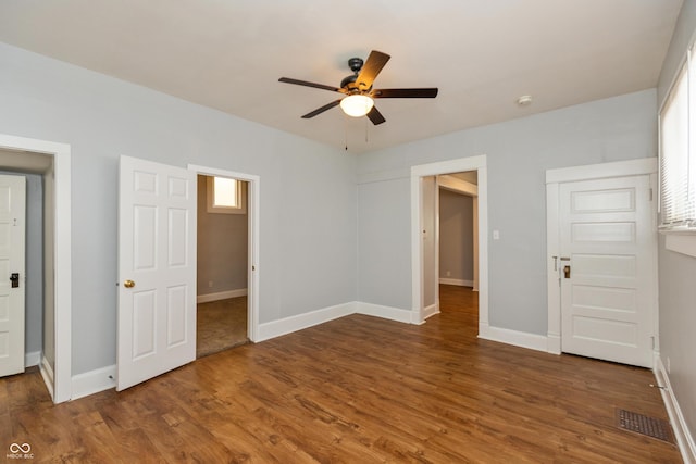 1661 S Talbott St, Indianapolis, IN 46225 - unfurnished bedroom with wood finished floors, baseboards, and ceiling fan