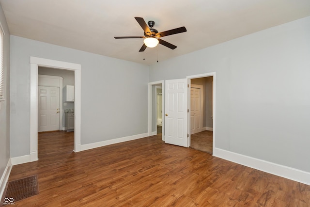 1661 S Talbott St, Indianapolis, IN 46225 - unfurnished bedroom featuring wood finished floors, baseboards, and a ceiling fan