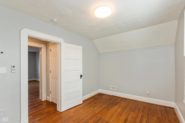 1661 S Talbott St, Indianapolis, IN 46225 - bonus room featuring wood-type flooring, baseboards, and lofted ceiling