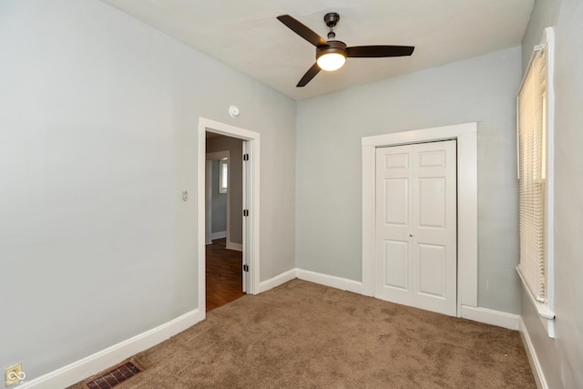 1661 S Talbott St, Indianapolis, IN 46225 - unfurnished bedroom with carpet flooring, baseboards, a closet, and a ceiling fan