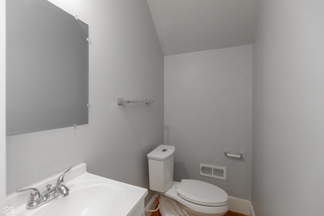 1661 S Talbott St, Indianapolis, IN 46225 - half bathroom with a sink, vaulted ceiling, and toilet