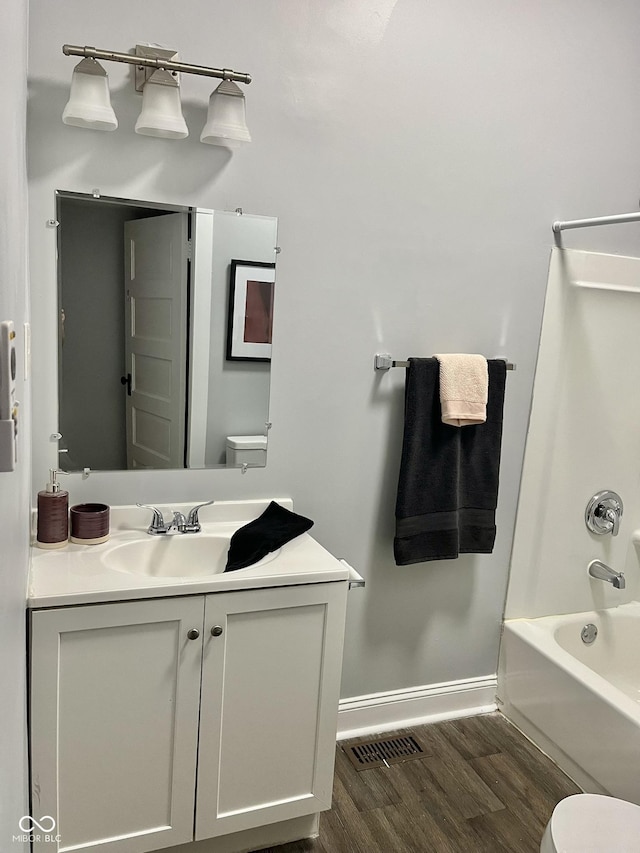 1661 S Talbott St, Indianapolis, IN 46225 - bathroom with vanity, wood finished floors, and tub / shower combination