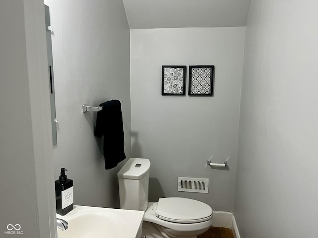 1661 S Talbott St, Indianapolis, IN 46225 - half bathroom featuring toilet and a sink