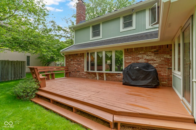 wooden terrace featuring a grill and fence