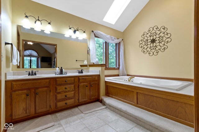 full bath featuring a skylight, vaulted ceiling, a bath, double vanity, and tile patterned floors