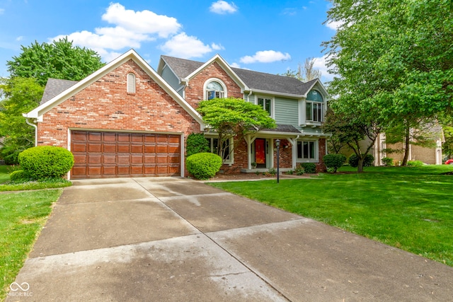 traditional-style house featuring brick siding, an attached garage, a front yard, and driveway