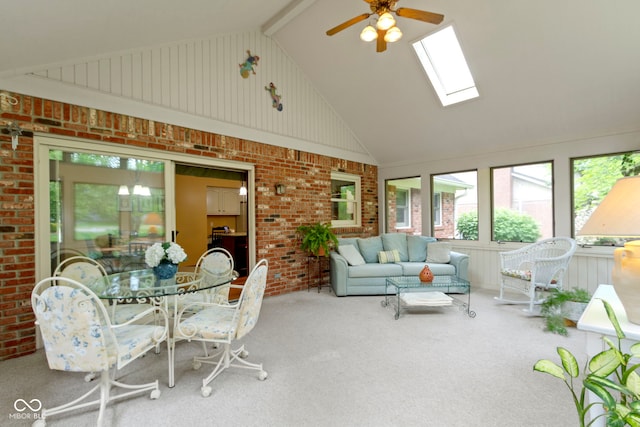sunroom with high vaulted ceiling, brick wall, carpet floors, and a skylight