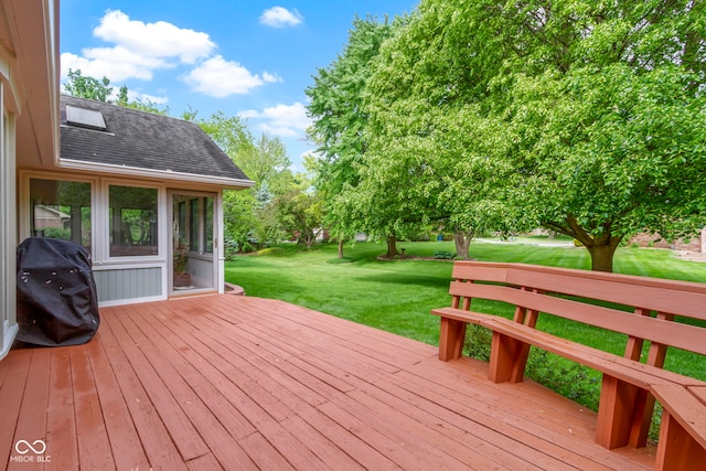 wooden deck with grilling area and a lawn