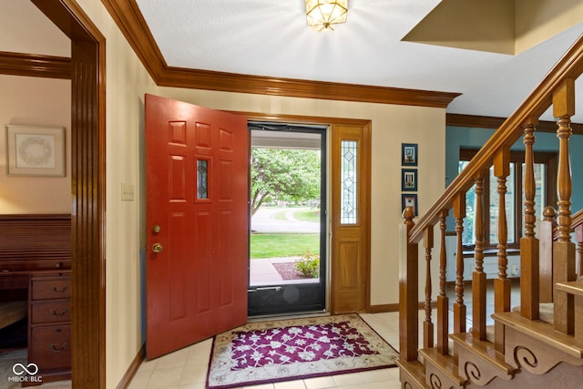 foyer entrance with crown molding, stairway, baseboards, and light tile patterned floors