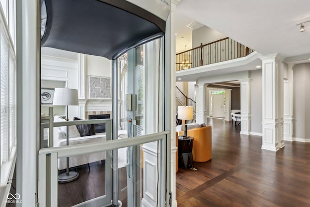 3744 Abney Point Dr, Carmel, IN 46077 - hallway featuring ornate columns, plenty of natural light, and wood finished floors