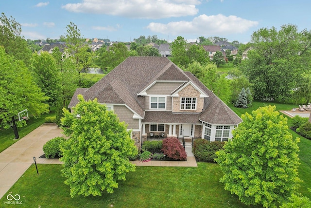 3744 Abney Point Dr, Carmel, IN 46077 - view of front of home featuring a front lawn, a porch, stone siding, and driveway