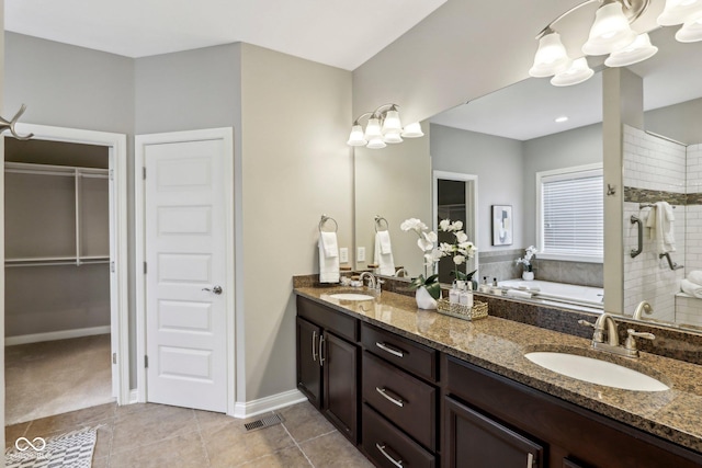3744 Abney Point Dr, Carmel, IN 46077 - bathroom featuring a chandelier, double vanity, a bath, a stall shower, and tile patterned flooring