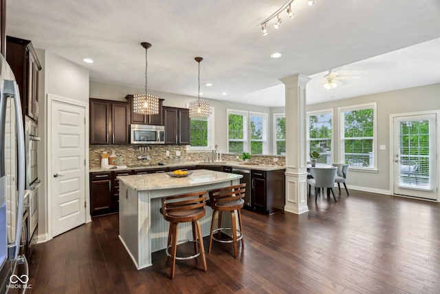 3744 Abney Point Dr, Carmel, IN 46077 - kitchen with appliances with stainless steel finishes, decorative columns, decorative backsplash, dark brown cabinetry, and recessed lighting