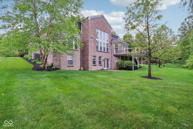 3744 Abney Point Dr, Carmel, IN 46077 - view of side of home with brick siding, a yard, and a deck