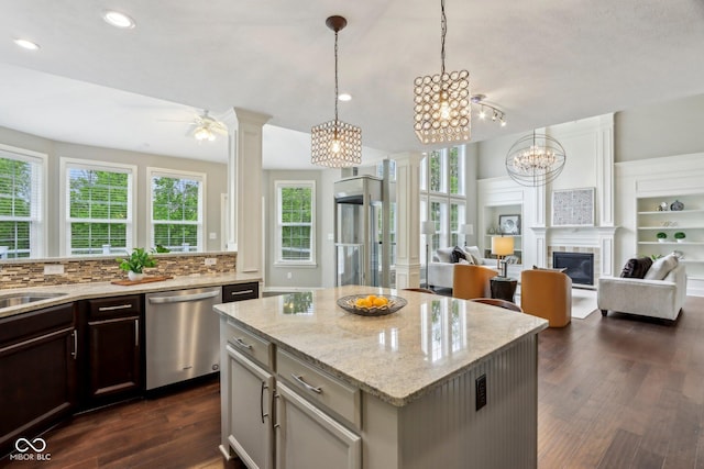 3744 Abney Point Dr, Carmel, IN 46077 - kitchen with dishwasher, ornate columns, dark wood-style floors, open floor plan, and light stone countertops